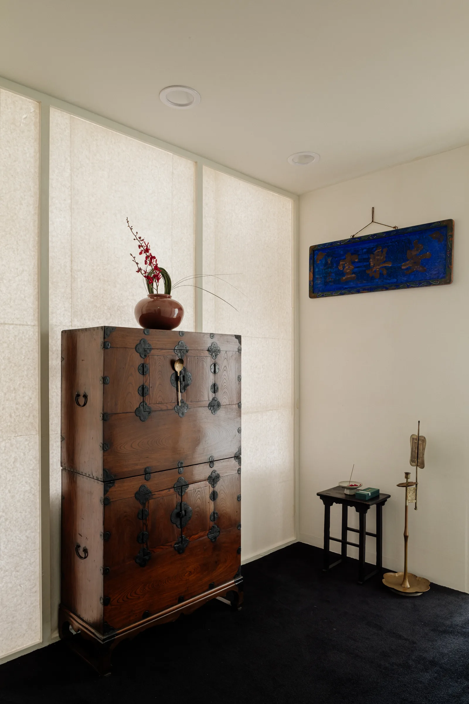 Joseon chest under slanted light through hanji curtain