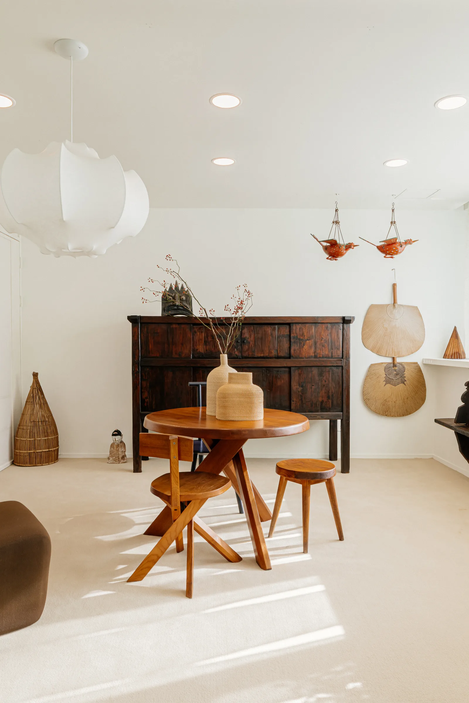 Interior mixing a Joseon cabinet with mid-century wooden table and lighting
