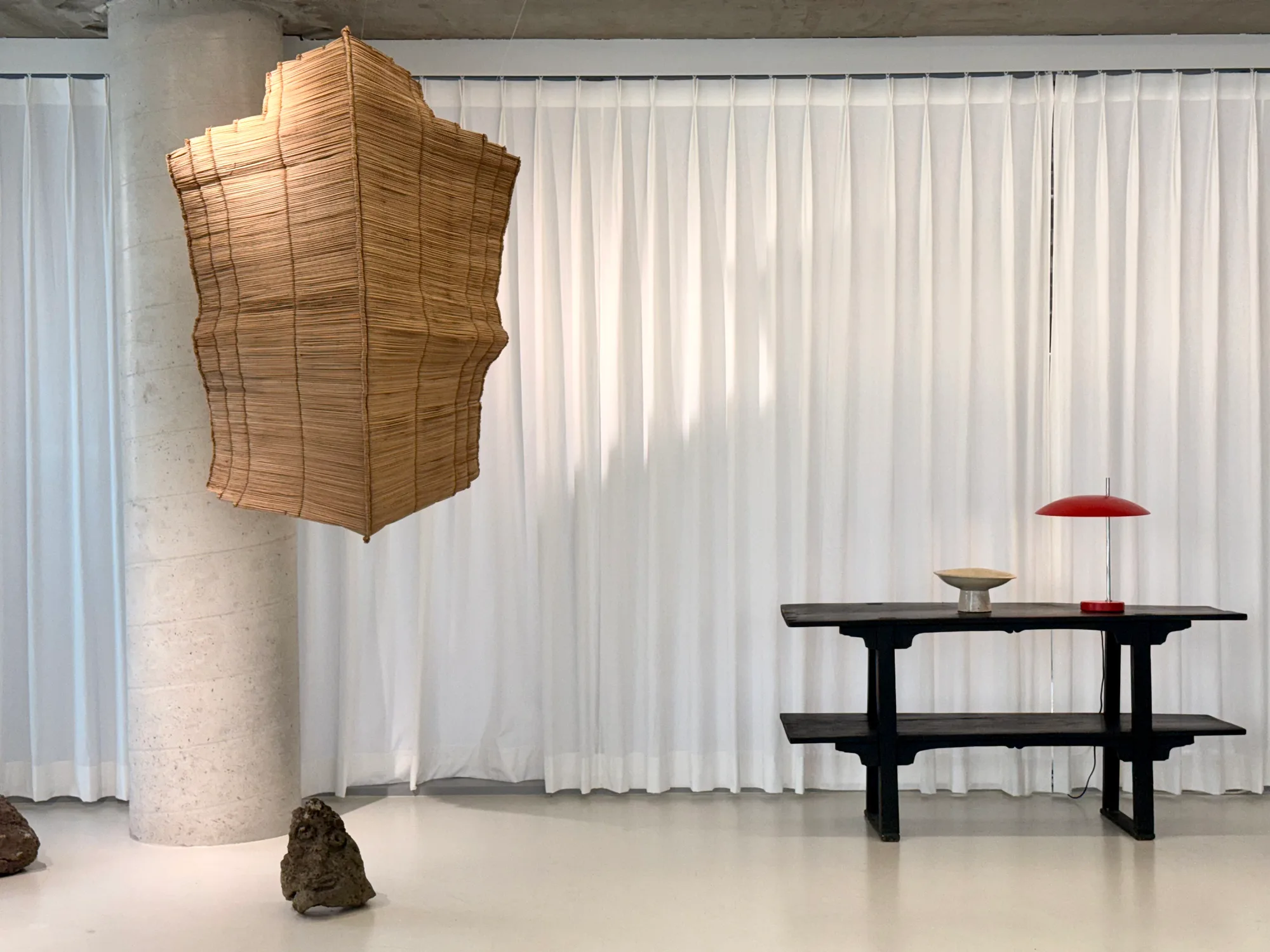 At the Le Modular exhibition in Yeonnam-dong — the jeopsari suspended beside a black lacquer table and a red lamp